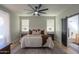 Comfortable main bedroom with a ceiling fan, bedside tables, and natural light at 2393 E San Gabriel Trl, Casa Grande, AZ 85194