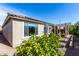 Exterior view of a home with a well-manicured backyard and covered patio and mature landscaping at 25913 W Sands Dr, Buckeye, AZ 85396