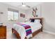 Bright bedroom featuring modern ceiling fan and a window at 25913 W Sands Dr, Buckeye, AZ 85396