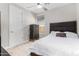 Bright bedroom featuring a modern ceiling fan, a window, and carpet flooring at 25913 W Sands Dr, Buckeye, AZ 85396