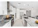 A bright open kitchen featuring stainless steel appliances and granite countertops at 25913 W Sands Dr, Buckeye, AZ 85396