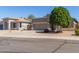 Single-story home featuring neutral stucco, a two-car garage, desert landscaping, and solar panels at 2605 N 115Th Dr, Avondale, AZ 85392