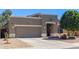 Single-story home featuring neutral stucco, a two-car garage, and front yard desert landscaping at 2605 N 115Th Dr, Avondale, AZ 85392