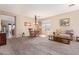 Inviting living room featuring neutral walls, plush carpet, and a decorative chandelier at 2605 N 115Th Dr, Avondale, AZ 85392