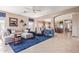 Inviting living room showcasing tile floors, ceiling fan, and a cozy seating area with a plush blue rug at 2605 N 115Th Dr, Avondale, AZ 85392