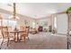 Inviting living room with neutral paint, large front-facing windows, and carpeted floors at 2605 N 115Th Dr, Avondale, AZ 85392