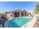 View of the pool and covered patio from the pool's edge, showing landscaping at 2605 N 115Th Dr, Avondale, AZ 85392