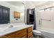 Bathroom featuring a wood vanity, toilet, shower, and dark door at 2716 N Kristen --, Mesa, AZ 85213