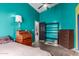 Bedroom with teal walls, hardwood floors, and a view into the hallway at 2716 N Kristen --, Mesa, AZ 85213