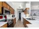 Well-lit galley kitchen featuring wood cabinets, stainless steel appliances, and white counters at 2716 N Kristen --, Mesa, AZ 85213