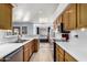 Bright kitchen features white countertops and wood cabinetry with backyard view at 2716 N Kristen --, Mesa, AZ 85213