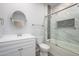 A bright bathroom featuring a glass-enclosed shower and a vanity with storage at 27227 N 147Th Ave, Surprise, AZ 85387