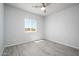 A bright bedroom with a ceiling fan and a sunlit window at 27227 N 147Th Ave, Surprise, AZ 85387