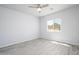 This bedroom features a ceiling fan, wood-look floors, and a window with a view of the desert landscape at 27227 N 147Th Ave, Surprise, AZ 85387