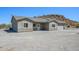 A charming home featuring stone accents and an expansive driveway in a desert landscape at 27227 N 147Th Ave, Surprise, AZ 85387