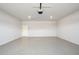 Clean, empty garage with painted floors and a white door at 27227 N 147Th Ave, Surprise, AZ 85387