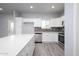 Modern kitchen featuring white cabinets, stainless steel appliances, and quartz countertops at 27227 N 147Th Ave, Surprise, AZ 85387