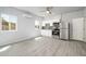 This kitchen features white cabinets, stainless steel appliances, and wood-look floors at 27227 N 147Th Ave, Surprise, AZ 85387