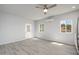 This living room features wood-look floors, a ceiling fan, and a door to the outside at 27227 N 147Th Ave, Surprise, AZ 85387