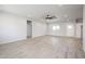 Spacious living room with gray floors, a ceiling fan, and natural light at 27227 N 147Th Ave, Surprise, AZ 85387