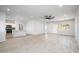 Open-concept living room showing floors, ceiling fan, and access to the kitchen at 27227 N 147Th Ave, Surprise, AZ 85387