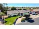 Aerial view of a single-story house featuring a well-maintained lawn, a quaint tree, and a paved driveway at 2919 W Kerry Ln, Phoenix, AZ 85027