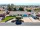 Aerial view of a single-story home with a well-manicured lawn, lush landscaping, and ample parking space at 2919 W Kerry Ln, Phoenix, AZ 85027