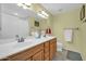 Bathroom features a double sink vanity with wood cabinets and a large mirror at 2919 W Kerry Ln, Phoenix, AZ 85027