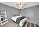 This modern bedroom features gray walls, tan carpet, a fan, and a white ladder shelf for minimalist storage at 2919 W Kerry Ln, Phoenix, AZ 85027