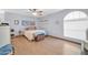 A cozy bedroom features light blue walls, wood-look floors, a ceiling fan, and an arched window letting in natural light at 2919 W Kerry Ln, Phoenix, AZ 85027