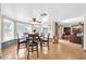 Well-lit dining room featuring wood floors, a ceiling fan, and large windows at 2919 W Kerry Ln, Phoenix, AZ 85027