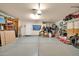 Garage interior showing a spacious floor, with a white door, shelves, and a red toy bus at 2919 W Kerry Ln, Phoenix, AZ 85027