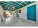 Garage interior showing a spacious concrete floor, blue painted doors, and white paneled walls at 2919 W Kerry Ln, Phoenix, AZ 85027