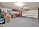 Garage interior showcasing a spacious concrete floor, open garage door, and storage items at 2919 W Kerry Ln, Phoenix, AZ 85027