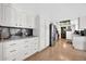 Galley kitchen with white cabinets, black backsplash, and stainless steel appliances at 2919 W Kerry Ln, Phoenix, AZ 85027