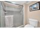 Shower features neutral tile, glass doors, a mounted showerhead, and a towel bar. The toilet is next to the shower at 2919 W Kerry Ln, Phoenix, AZ 85027