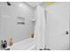 Shower/tub features bright light, white shower curtain and convenient storage niche at 2919 W Kerry Ln, Phoenix, AZ 85027