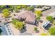 Aerial view of a desert home showcasing a tile roof, three-car garage, and mature landscaping at 2924 W Here To There Dr, Phoenix, AZ 85086