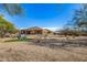 Expansive backyard with desert landscape, lounge chairs, and covered patio at 2924 W Here To There Dr, Phoenix, AZ 85086