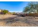 View of the property's expansive backyard with a trailer and gate, perfect for outdoor activities at 2924 W Here To There Dr, Phoenix, AZ 85086