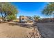 Spacious backyard featuring a large RV or trailer parked, complemented by mature trees and desert landscaping at 2924 W Here To There Dr, Phoenix, AZ 85086