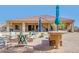 Back patio area with seating and outdoor kitchen with pavers and desert landscaping at 2924 W Here To There Dr, Phoenix, AZ 85086