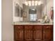 A bathroom featuring a granite countertop vanity with wood cabinets and great lighting at 2924 W Here To There Dr, Phoenix, AZ 85086