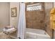 Bathroom with shower and tub, decorative window, and neutral brown tile at 2924 W Here To There Dr, Phoenix, AZ 85086