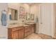 Bathroom showcasing double sink vanity with granite counters, wood cabinets and framed mirrors at 2924 W Here To There Dr, Phoenix, AZ 85086