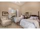 A cozy bedroom with two beds, vintage decor, and plenty of natural light at 2924 W Here To There Dr, Phoenix, AZ 85086