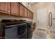 Well-organized laundry room with modern appliances and ample cabinet space at 2924 W Here To There Dr, Phoenix, AZ 85086