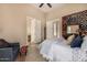 A main bedroom featuring an ensuite bathroom, with a large bed and an accent chair at 2924 W Here To There Dr, Phoenix, AZ 85086