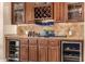 Wet bar with wine storage, glass shelving, and elegant cabinetry at 2924 W Here To There Dr, Phoenix, AZ 85086