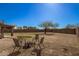 Spacious backyard featuring desert landscaping and a fire pit, perfect for outdoor gatherings at 2977 W Mira Dr, San Tan Valley, AZ 85144